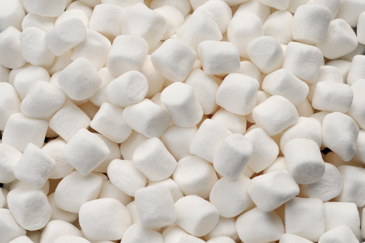 A load of white, non-vegan marshmallows are pictured laid atop one another.